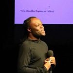 Steve Zakuani speaking to Bainbridge High School students and families for the TBB Foundation.